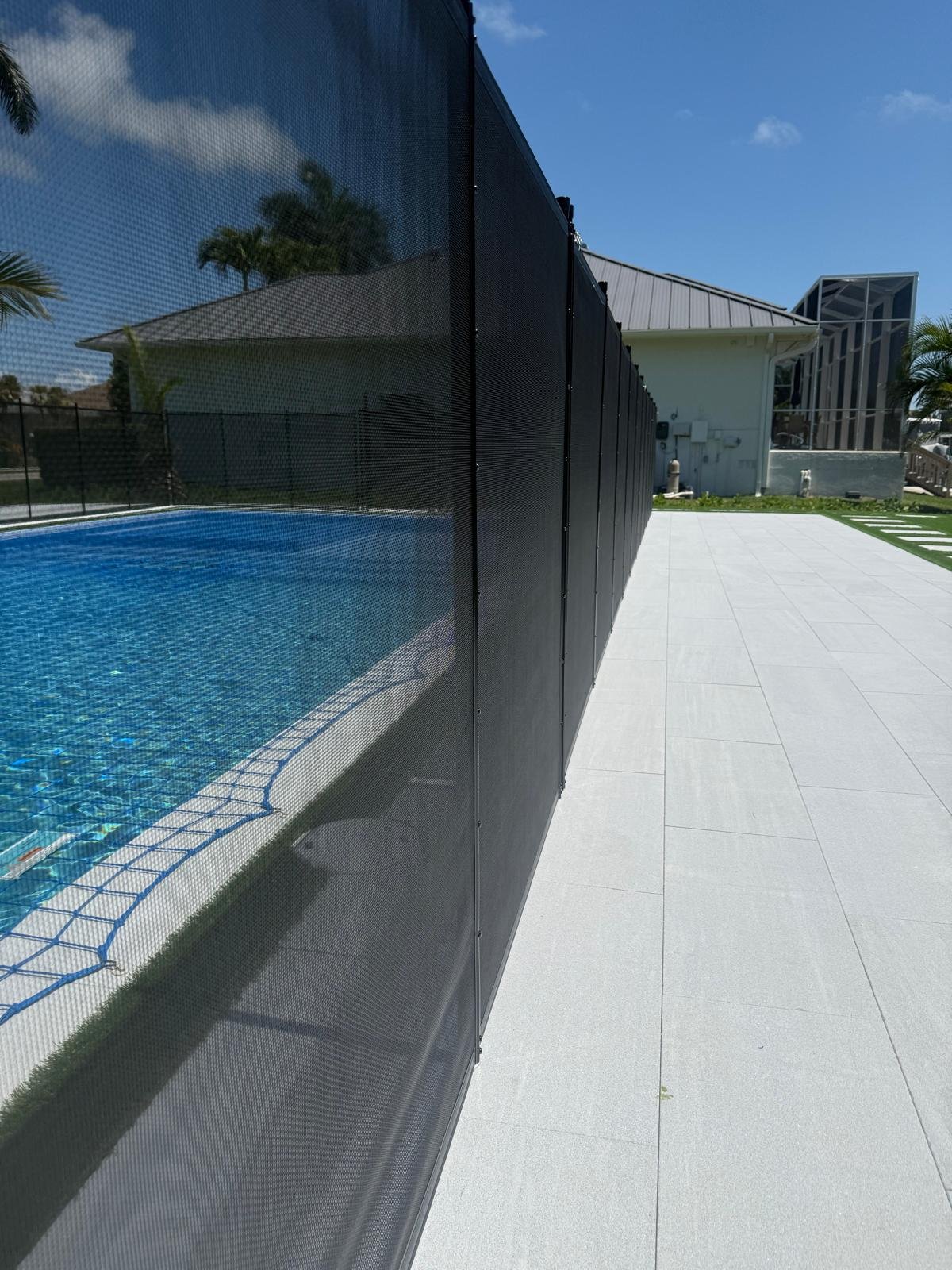 Removable pool fence close up in black mesh