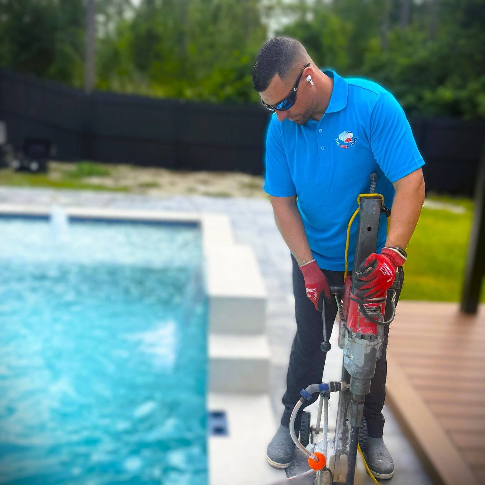 Professional Pool fence installer using drill.