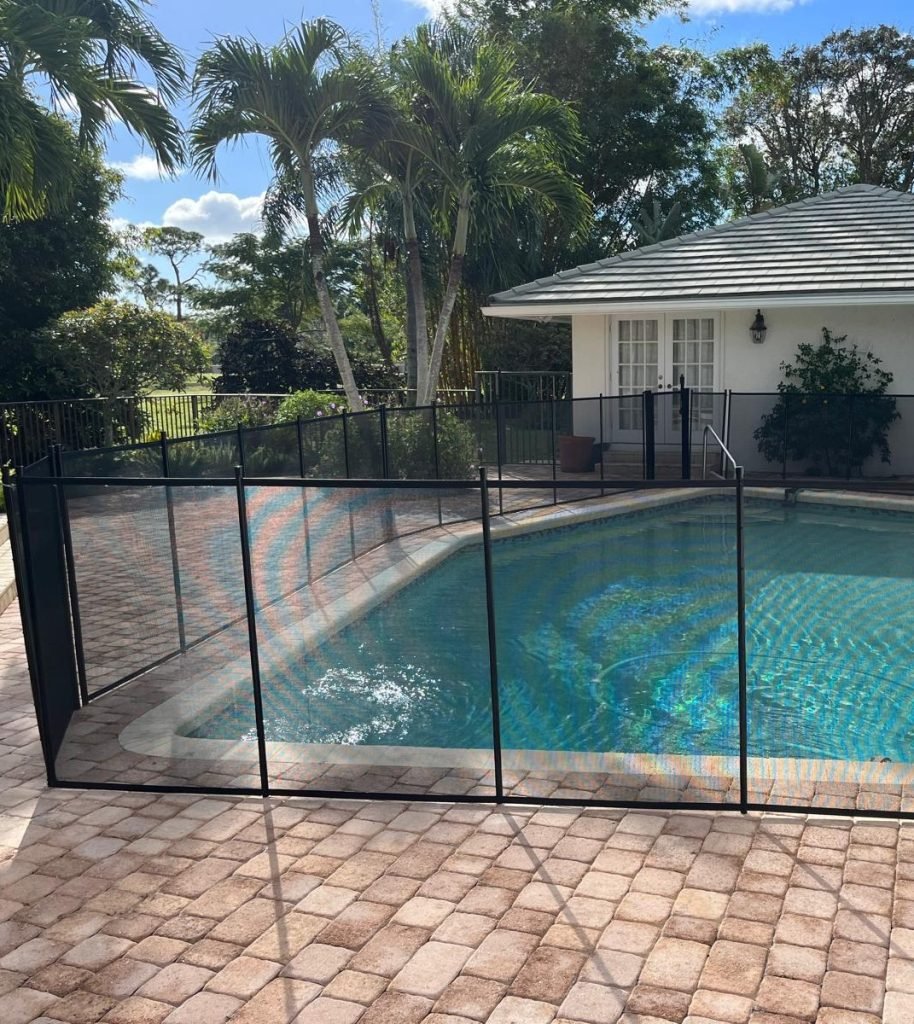 Boca Raton FL Black Mesh Pool Fence Installation Removable black pool safety fence around a residential swimming pool in Boca Raton, FL